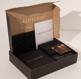 black gift box with gold branding showing delivery details