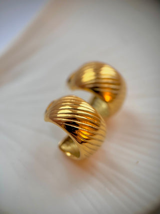 18k gold plated chunky hoops with etched design on a white jewellery dish