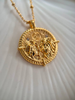 18k gold plated brass Gemini star sign Zodiac Necklace with cubic zirconia stones and intricate detailing on a coin disc pendant and on fine ball chain.