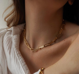 18k Gold plated brass Paperclip Chain worn by a model wearing a cream shirt off the shoulder.