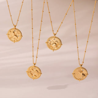 Sagittarius, pisces, cancer and Aquarius Necklaces - Gold Lunar hanging next to each other with the sunlight and shadows