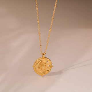 18k gold plated brass Gemini star sign Zodiac Necklace with cubic zirconia stones and intricate detailing on a coin disc pendant and on fine ball chain.