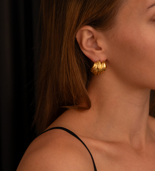 18k gold plated Chunky Curve Round Studs worn on a model wearing black strappy top