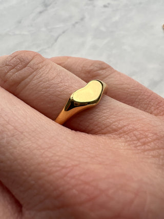 gold plated heart band ring worn on model hand 