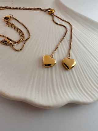 heart lariat necklace in 18k gold plated displayed on a white jewellery dish