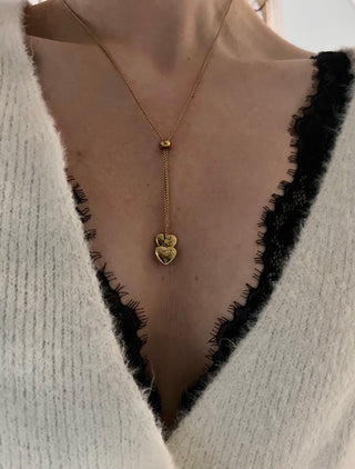 18k gold plated heart lariat necklace worn on a model with a v neck fluffy white jumper and black lace bra modern stylish jewellery