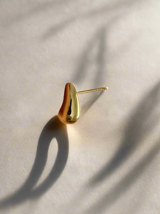 18k gold plated Mini Teardrop Stud Earrings in the sunlight with a shadow