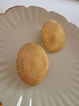 18k gold plated Large round textured studs earrings displayed on white jewellery dish