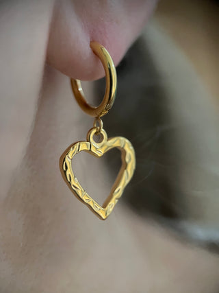 18k gold plated molten heart hoop earrings worn on a model ear