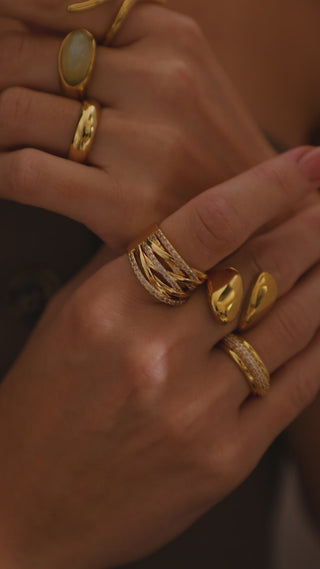 18 gold plated stackable rings worn on model wearing a Zara brown waistcoat 