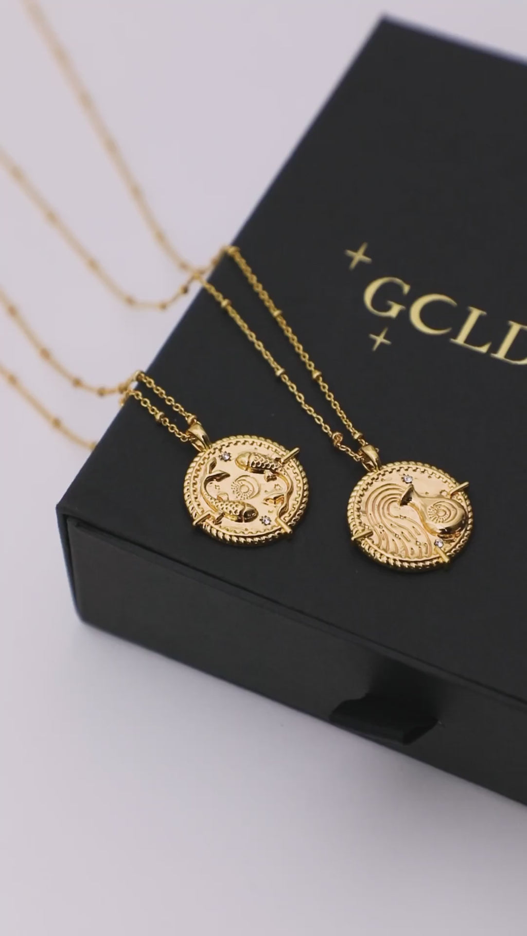 18k gold plated brass Taurus Zodiac Necklace with cubic zirconia stones and intricate detailing on a coin disc pendant and on fine ball chain on a jewellery gift box also featuring star signs 