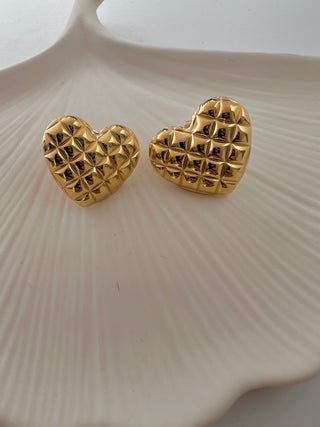 18k gold plated quilted heart earrings oversized chunky earrings displayed on a white jewellery dish