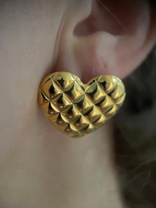 18k gold plated quilted heart oversized chunky earrings worn on model modern jewellery