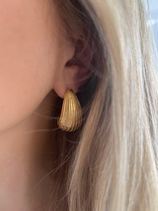 18k gold plated Ribbed Curved Earrings - Gold Lunar worn on model with blond hair