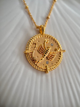 18k gold plated brass Scorpio star sign Zodiac Necklace with cubic zirconia stones and intricate detailing on a coin disc pendant and on fine ball chain.