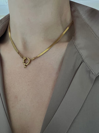 gold plated snake chain worn by model wearing a ZARA brown silk shirt open at the front exposing black lace bra trim